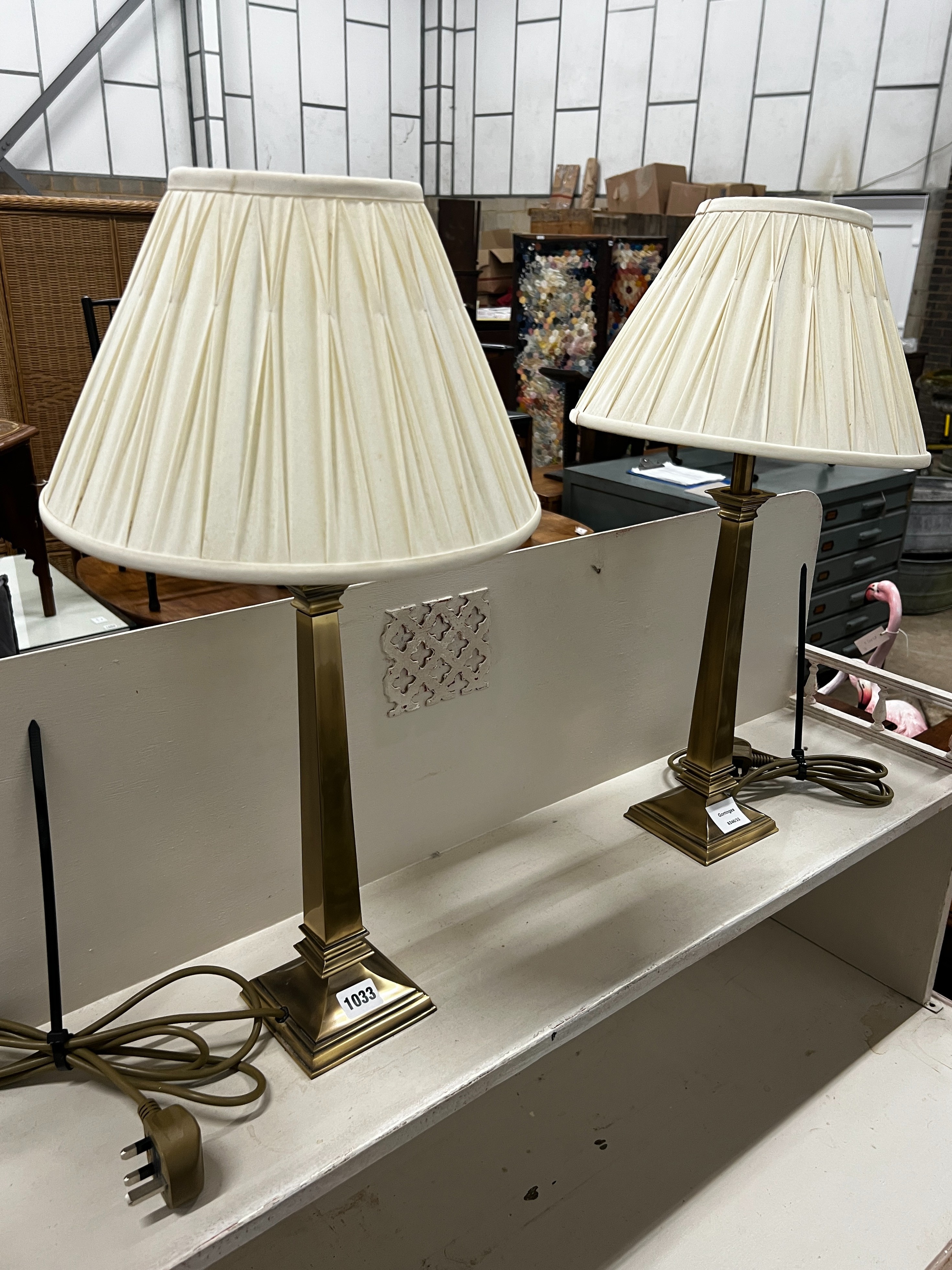 A pair of contemporary brass effect table lamps and shades, height including shades, 58cm